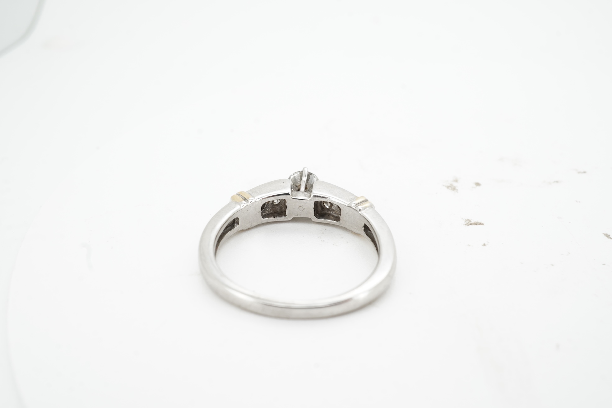 A diamond half-hoop ring, mid 19th century, pavé-set to the front with three rows of cushion-shaped diamonds totalling approximately 0.80 carats, to foliate carved shoulders, mounted in gold, size O, gross weight approxi